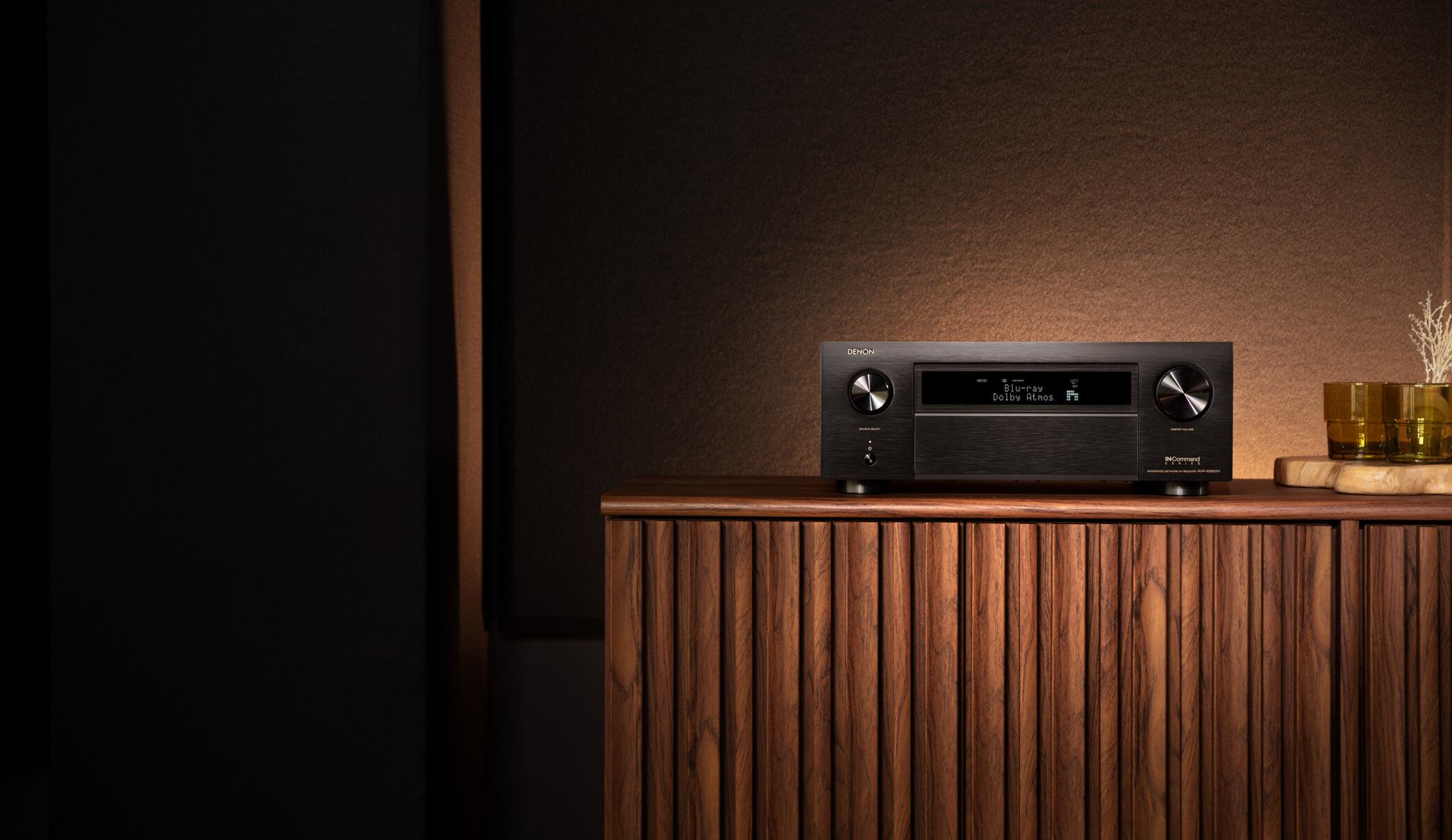 Denon stereo receiver and turntable on a living room console
