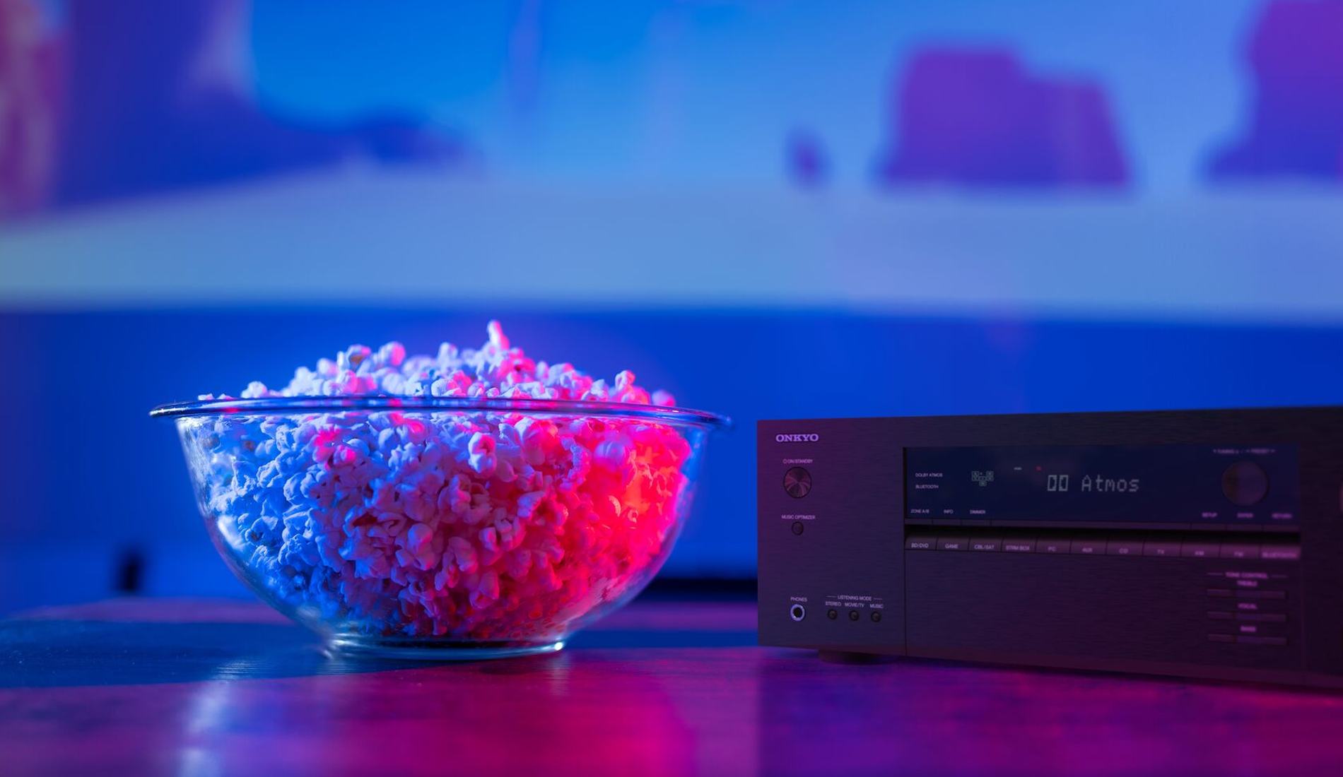 Family watching a film with an Onkyo home theater system